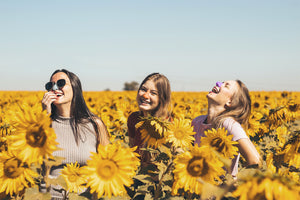 3 women wearing Noz sunscreen protection while out on a sunny day